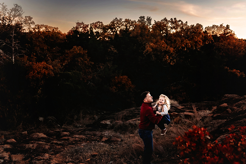rva photographers, dad catching little blonde haired girl with fall colors in back