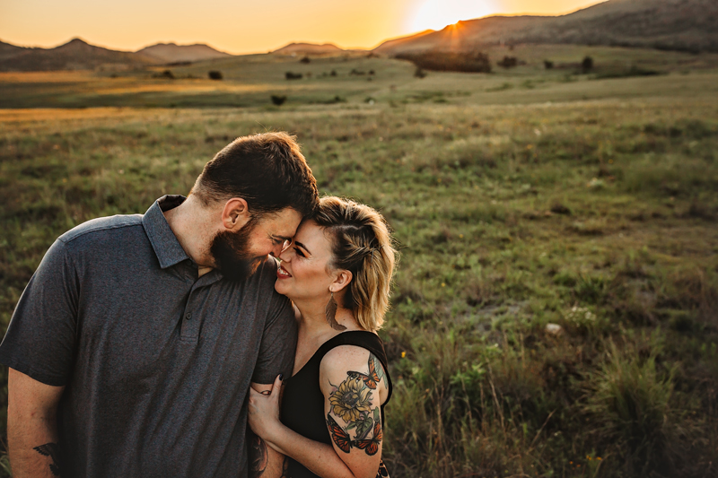 Moseley, Virginia photographer, couple touching foreheads in field with sunset behind them