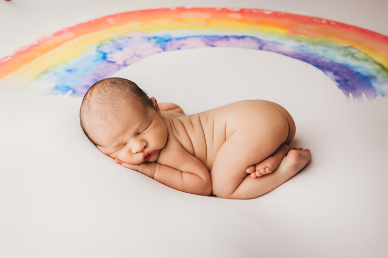 Chester, Virginia newborn photographer, newborn boy asleep on rainbow backdrop in bum up position