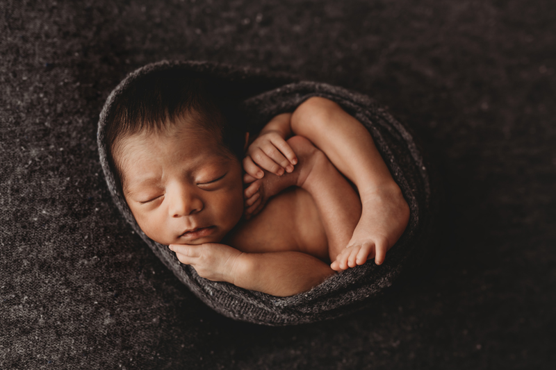 Midlothian, Virginia newborn photographer, newborn hispanic boy curled up asleep in gray speckled fabric