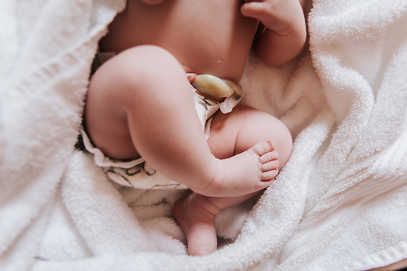 Midlothian, Virginia birth photographer, newborn baby's feet and showing fresh umbilical cord and diaper