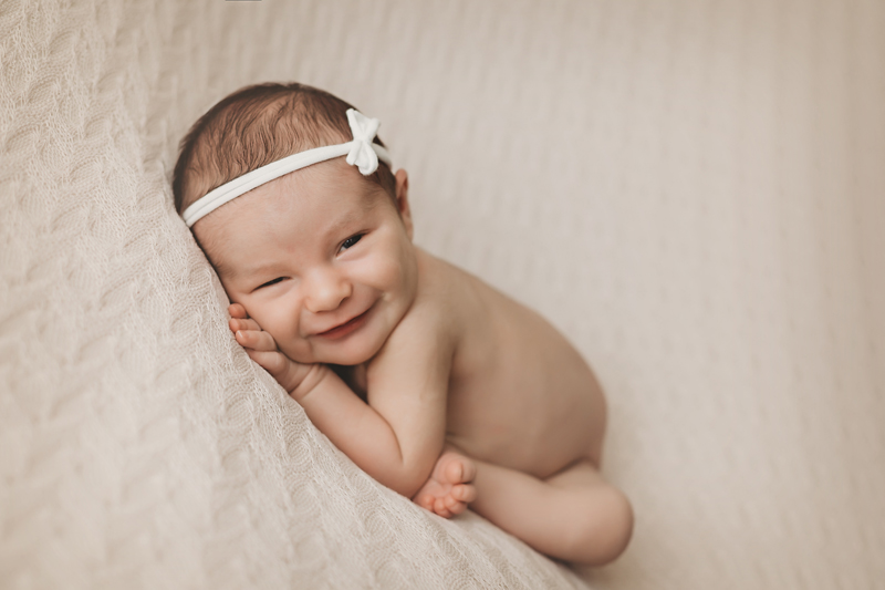 Colonial heights, Virginia newborn photographer, smiley newborn girl on ivory background