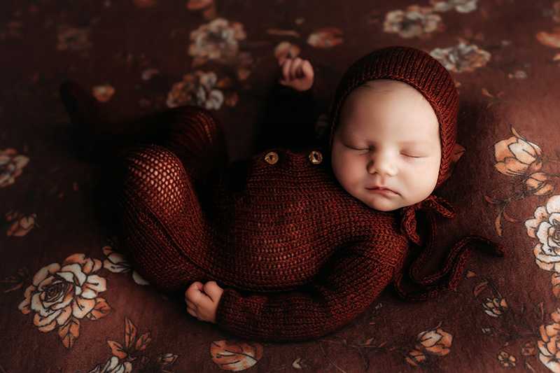 Chester, Virginia newborn photography, Chesterfield, Virginia newborn photographer,  newborn girl sleep wearing cinnamon knit outfit on rust flowery background