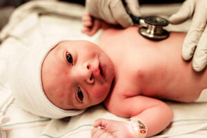 Charlottesville, Virginia birth photographer, newborn baby with stethoscope listening to his heart