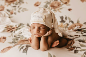 Richmond photographer, newborn baby girl in froggy pose on flowery backdrop