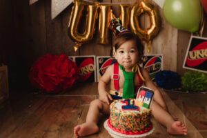 Boy sitting with UNO cake in Richmond family photography studio