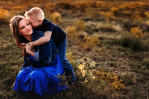 duncan Oklahoma photographer, mom kneeling on ground with son hugging her around the neck