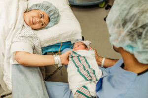 Richmond, Virginia birth photographer, mom meeting newborn in OR after C-section